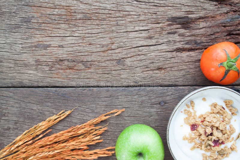 Yogurt with granola on top with green apple, strawberries and to