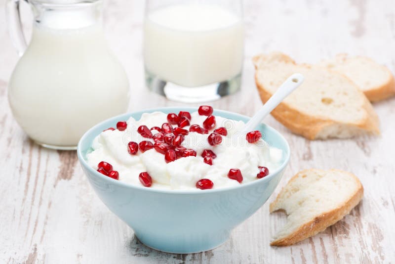 Yogurt with pomegranate, milk and bread stock photos