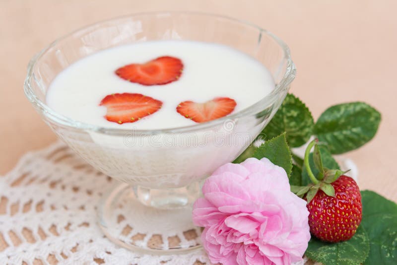 Yogurt with strawberry in glass bowl