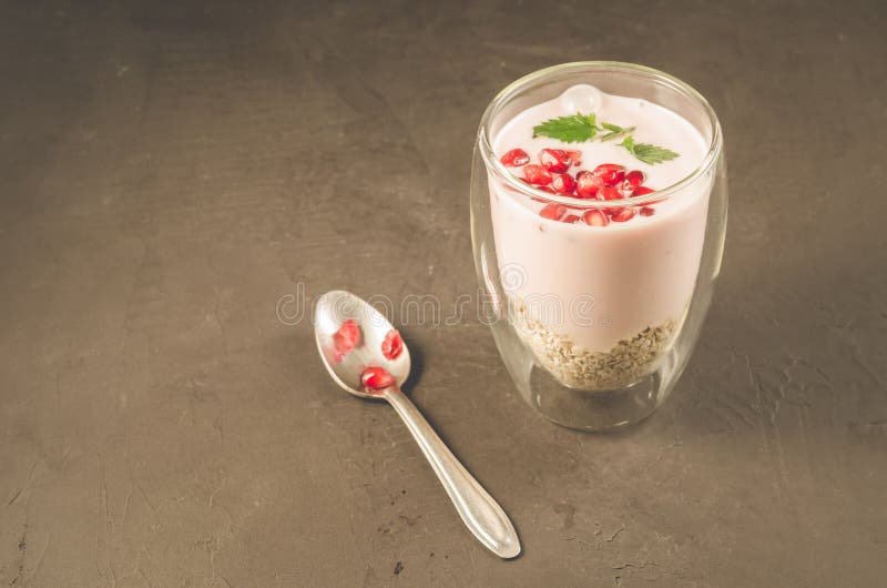Yogurt. Sweet organic dessert with yogurt, garnet and mint in beautiful glasses on dark background with copy space royalty free stock photography Yogurt. Sweet organic dessert with yogurt, garnet and mint in beautiful glasses on dark background with copy space royalty free stock photography