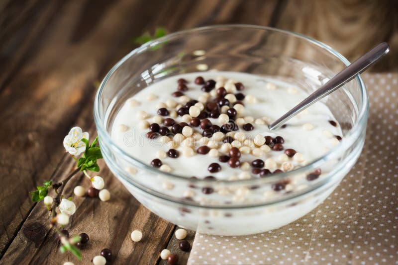 Yogurt with White and Brown Chocolate Balls, Soft Focus Stock Image
