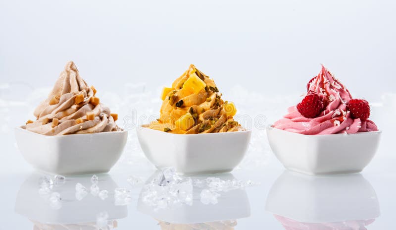 Assorted Flavor Delicious Frozen Yogurts on Small White Bowls Isolated on White Background. Assorted Flavor Delicious Frozen Yogurts on Small White Bowls Isolated on White Background