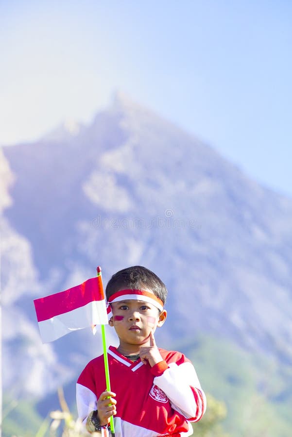 Young People with Flag. Indonesia Flag, Indonesia Independance Day with mt Merapi background stock photo Young People with Flag. Indonesia Flag, Indonesia Independance Day with mt Merapi background stock photo