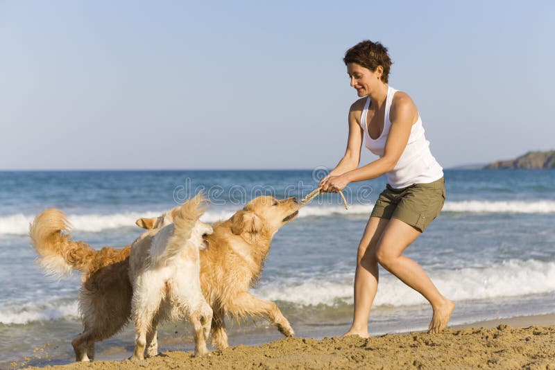 Yong girl playing with her dogs