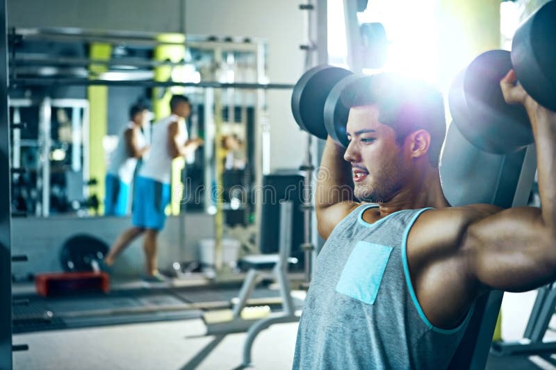 You Can Do it. a Man Doing a Upperbody Workout at the Gym. Stock Photo Image of sitting