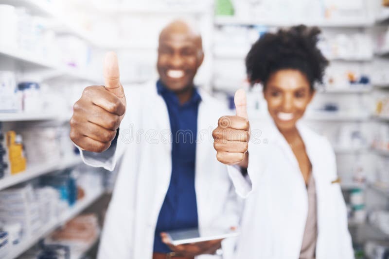 You can trust us. two pharmacists showing thumbs up.