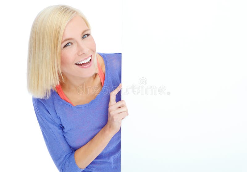 You cant go wrong with this product. A pretty young woman looking at a blank placard while isolated on white.