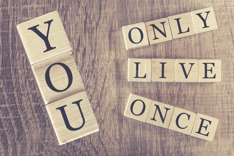 You Only Live Once (YOLO) message formed with wooden blocks