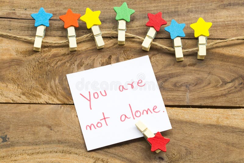 You are not alone message card handwriting with colorful wooden star clips arrangement flat lay postcard style royalty free stock photography You are not alone message card handwriting with colorful wooden star clips arrangement flat lay postcard style royalty free stock photography