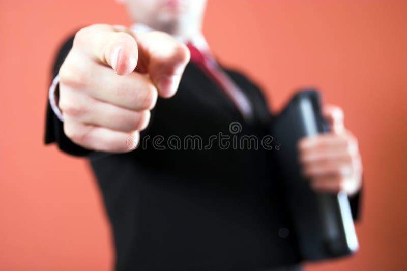 Businessman pointing to the viewer and holding a laptop. Male hand holding businessman stock images, royalty-free photos and pictures