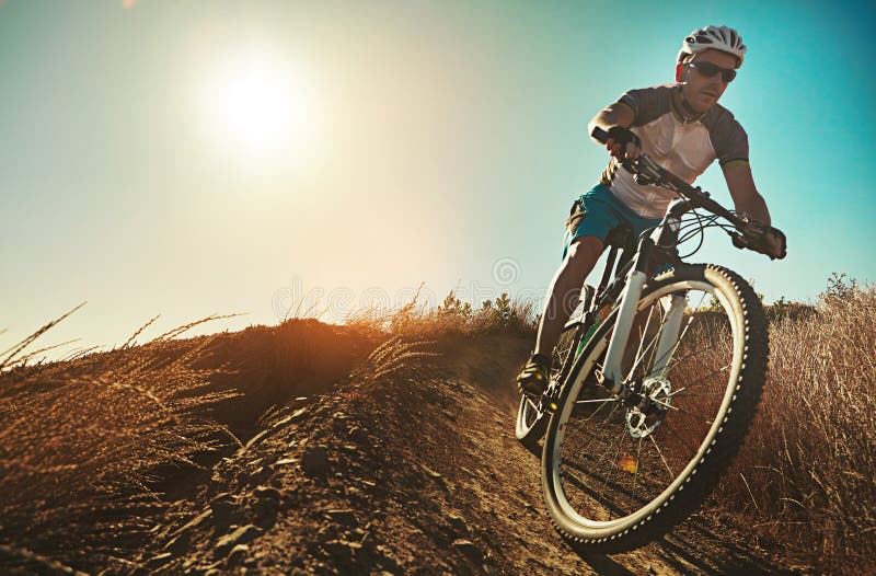 Youll find yourself fully living in the moment. a man out cycling in the countryside. stock images