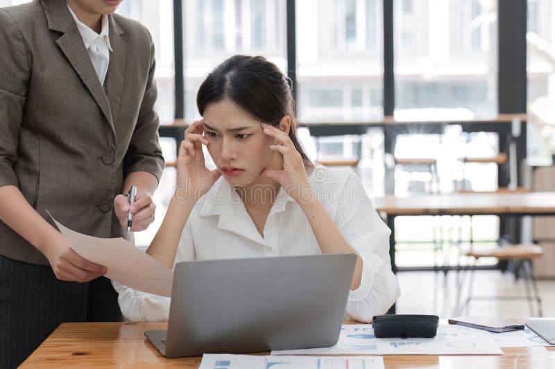 Young Accountant Feeling Stressed While Working on Financial Reports in a Modern Office Setting stock images