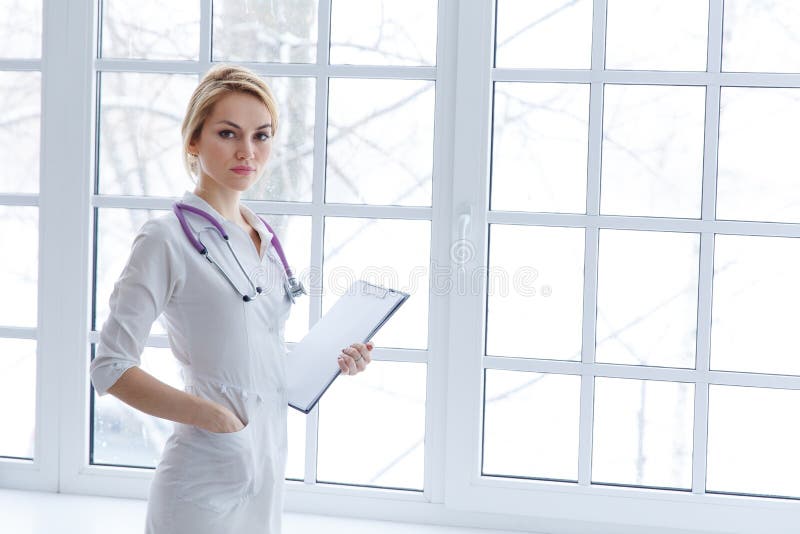 Young adult attractive woman doctor stand with document paper.