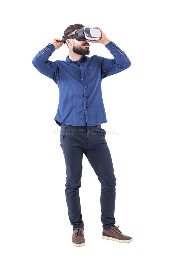 Young adult bearded man trying on virtual reality glasses looking up. royalty free stock photo Young adult bearded man trying on virtual reality glasses looking up. royalty free stock photo