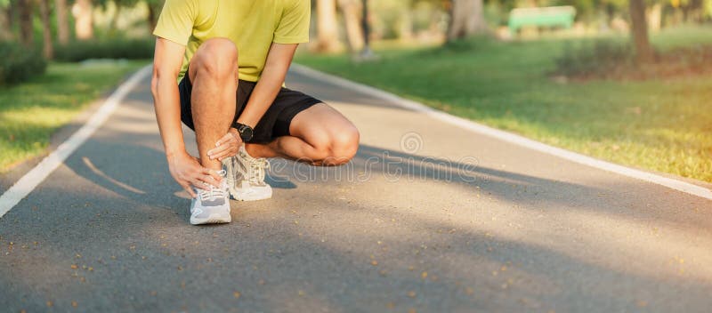 Young adult male with his muscle pain during running. runner man having leg ache due to Ankle Sprains or Achilles Tendonitis.