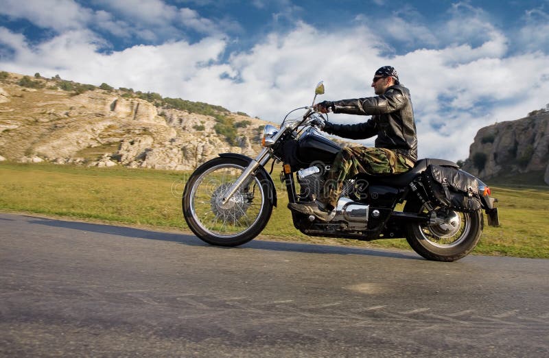 Young adult rebel biker riding a chopper royalty free stock image Young adult rebel biker riding a chopper royalty free stock image