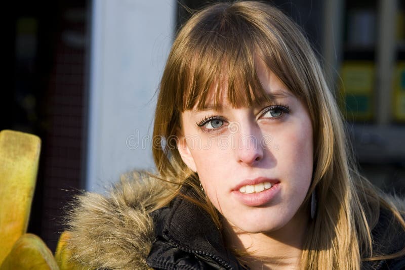 Young Adult Woman with Blond Hair Looking Away