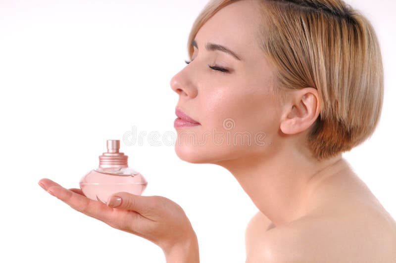 Young adult woman enjoying the smell of a flowery scent royalty free stock photography Young adult woman enjoying the smell of a flowery scent royalty free stock photography