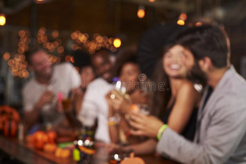 Young Adults Socialising at a Party in a Bar, Defocussed Stock Image