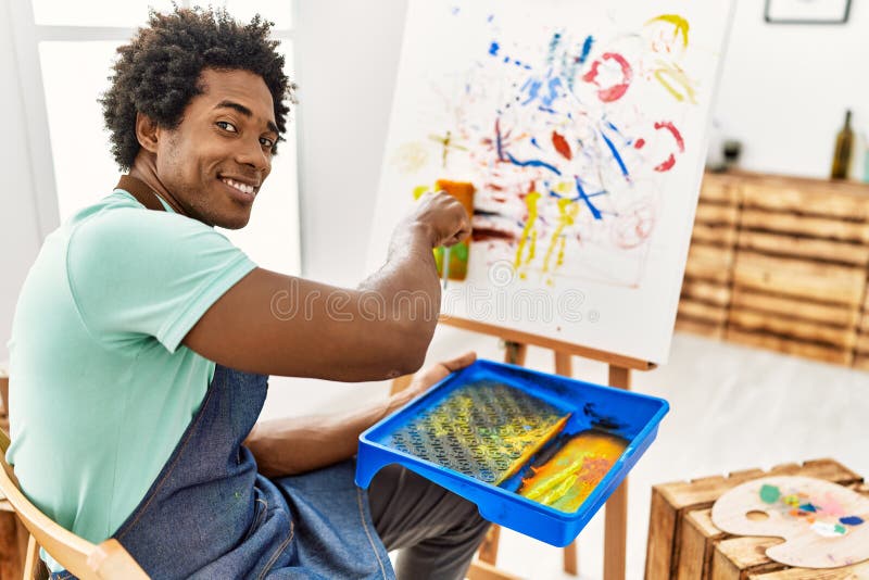 Young African American Artist Man Drawing Using Paint Roller at Art