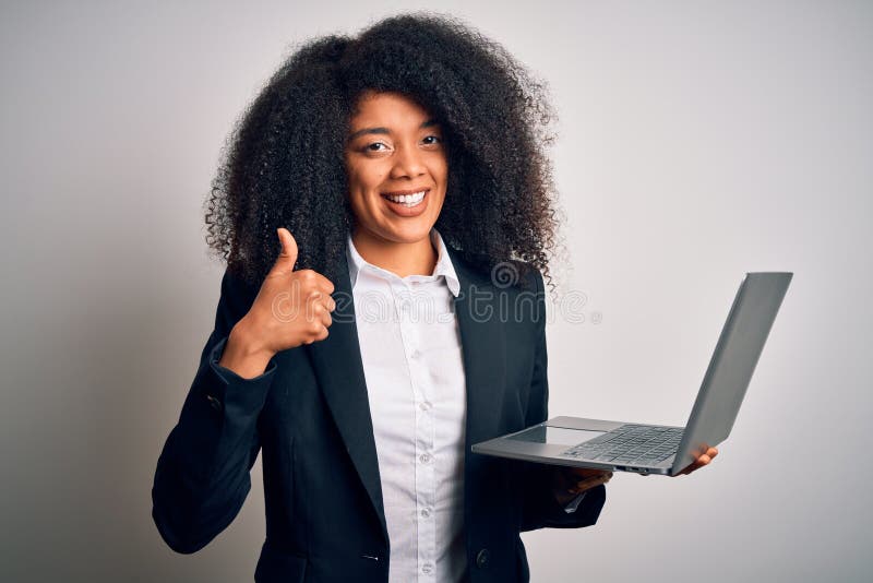 Young african american business woman with afro hair using computer laptop from job happy with big smile doing ok sign, thumb up