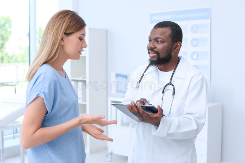 Young African-American doctor speaking with his patient stock photo Young African-American doctor speaking with his patient stock photo