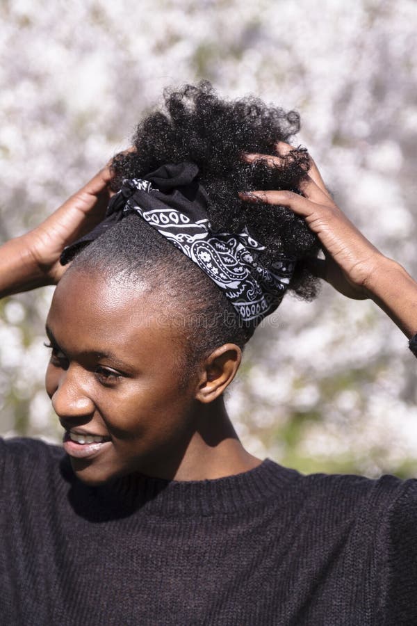 Young African Girl in Blossom Park Fixes Hairstyle Stock Image - Image of female, black: 150264725 Young African Girl in Blossom Park Fixes Hairstyle Stock Image - Image of female, black: 150264725