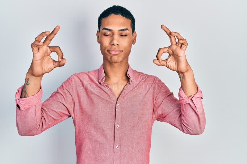 Young african american guy wearing casual clothes relax and smiling with eyes closed doing meditation gesture with fingers royalty free stock photography