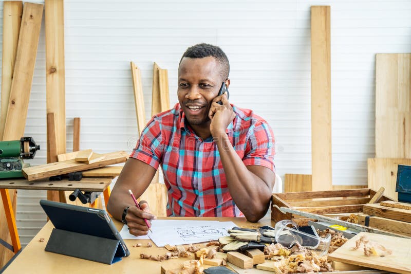 Young carpenter african american man looking and choosing wood and