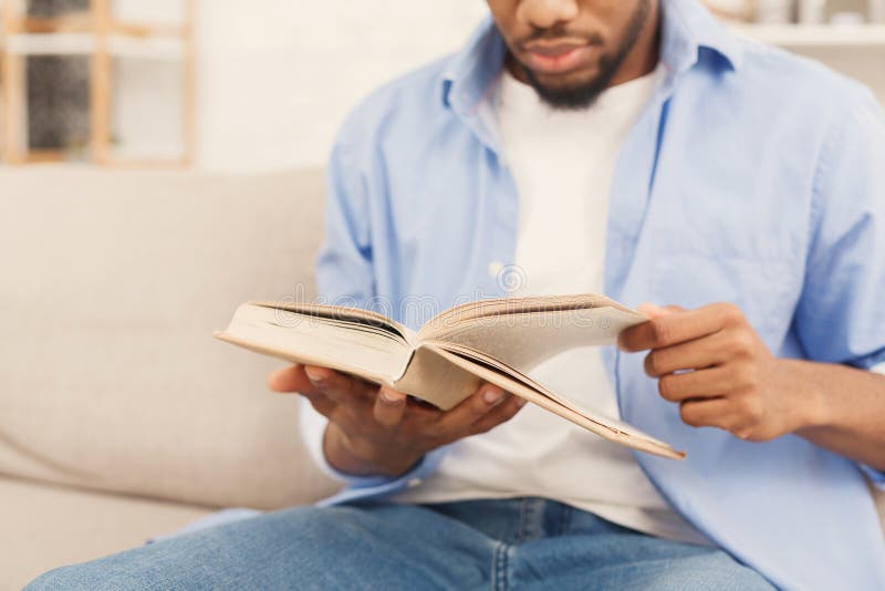 Young african-american man reading book at home royalty free stock image Young african-american man reading book at home royalty free stock image