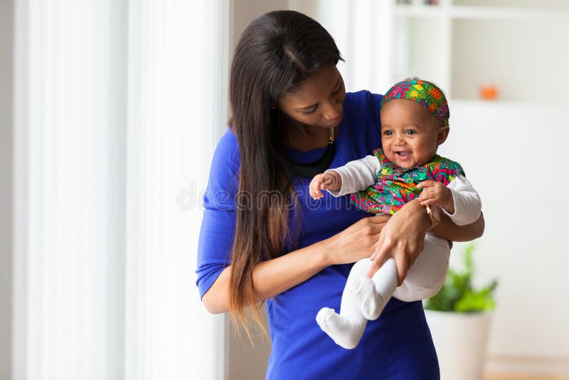 African american mother playing with her baby girl stock photos African american mother playing with her baby girl stock photos