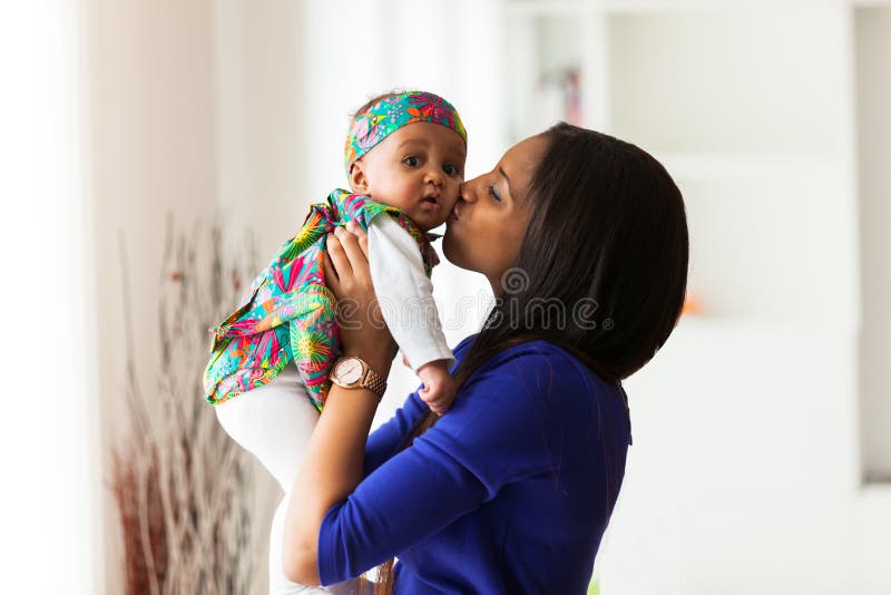 Young african american mother playing with her baby girl