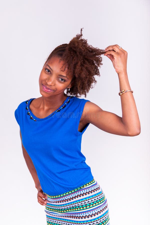 Young African American woman holding her frizzy afro hair - Blac royalty free stock photo Young African American woman holding her frizzy afro hair - Blac royalty free stock photo
