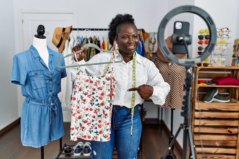 Young African American Woman Shopkeeper Selling Clothes Online at ...