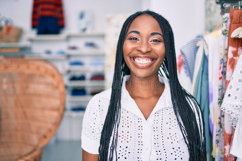 Young african american woman smiling happy at clothing store stock images