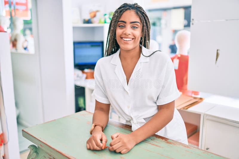 Young african american woman smiling happy working at the till at retail shop royalty free stock photography