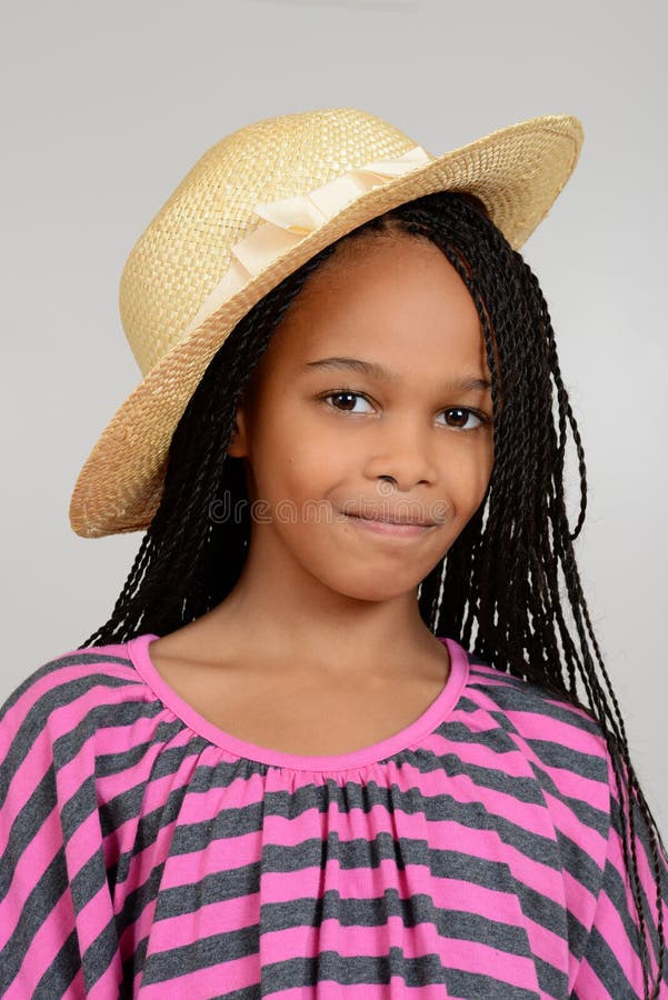 Young african girl wearing a straw hat