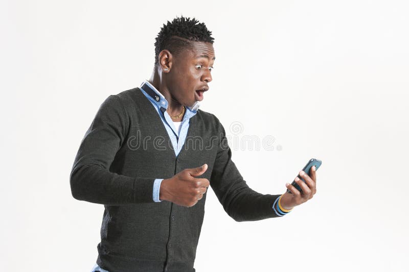 Young african guy looking at cell phone