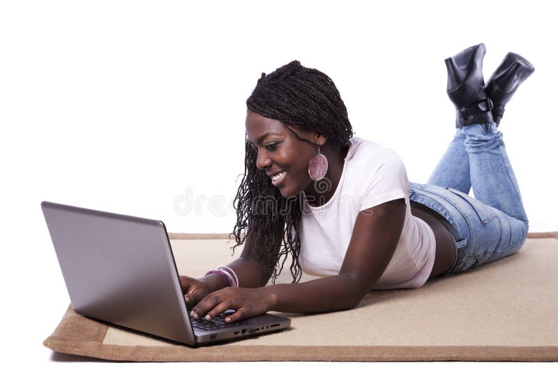 Young african woman working with her laptop stock photography