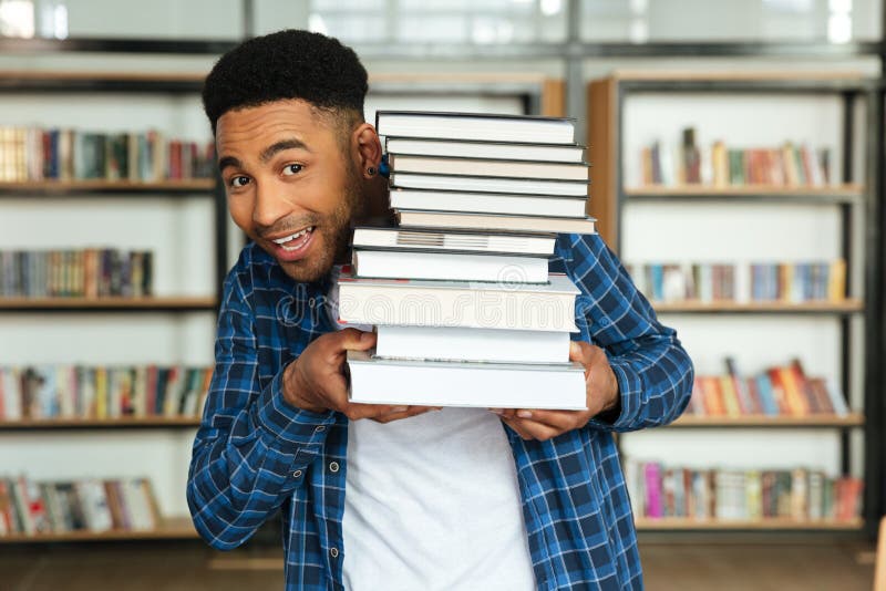 Young Afro American Male Student Holding Stack of Books Stock Photo ...