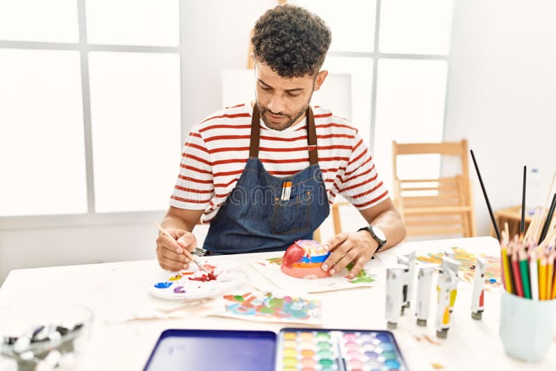 Young Arab Artist Man Painting Ceramic at Art Studio Stock Image