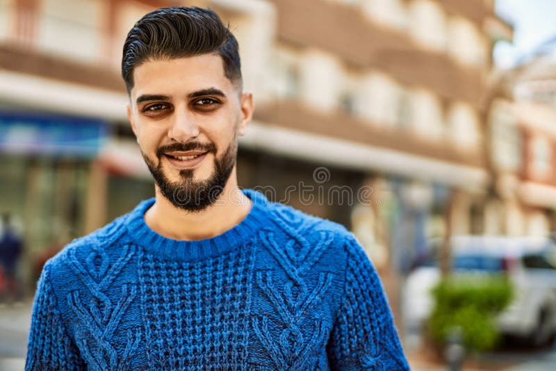 Young arab man smiling confident at street stock photos