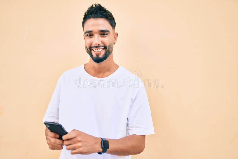 Young Arab Man Smiling Happy Using Smartphone at the City Stock Photo ...