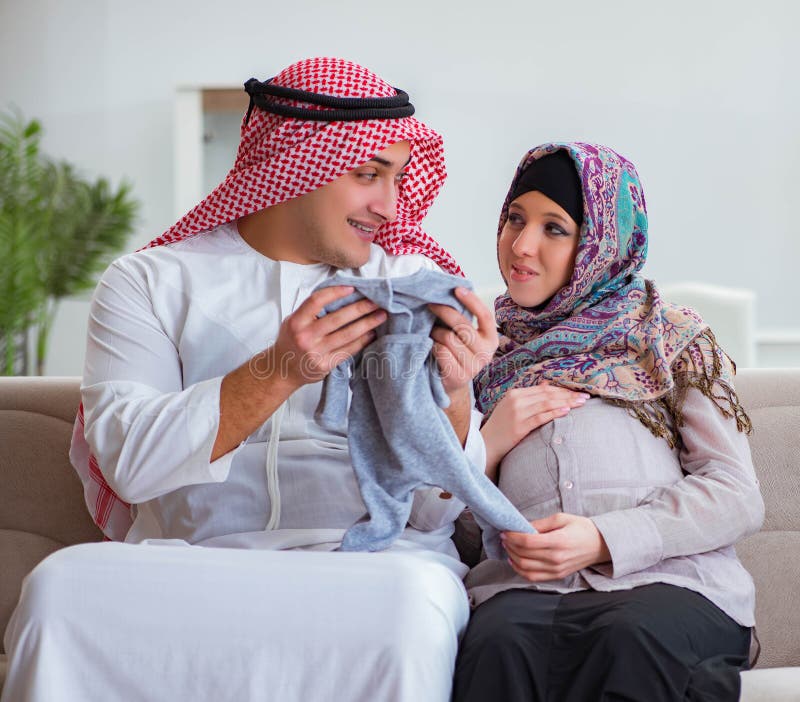 Young Arab Muslim Family With Pregnant Wife Expec