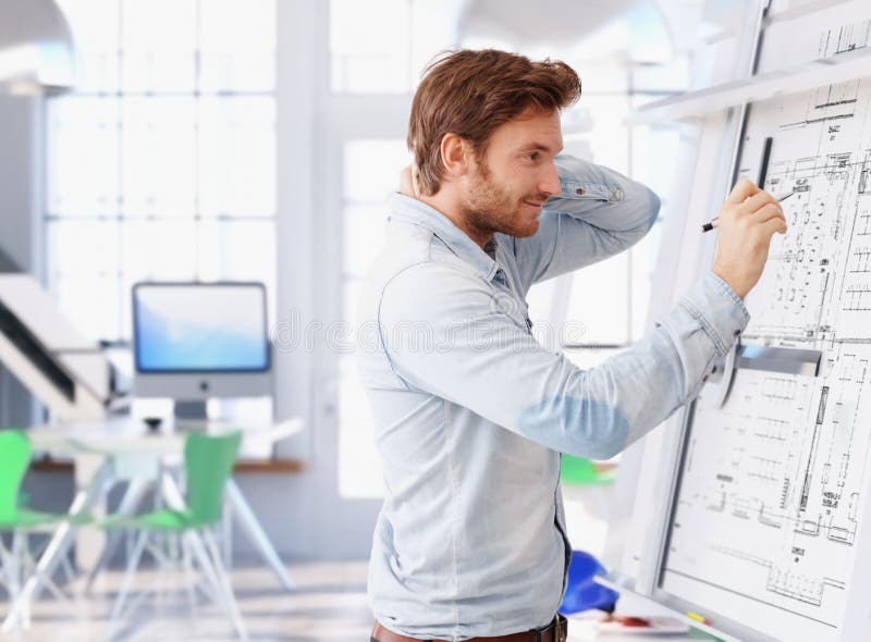 Young architect working at drawing board royalty free stock images