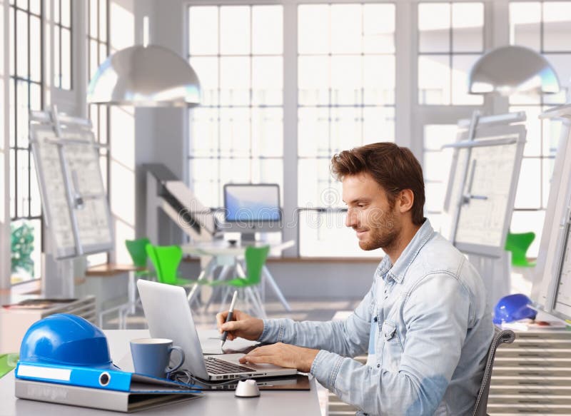Young architect working at office desk royalty free stock photo