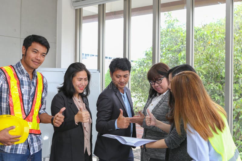 Young architectural team at work. Office worker viewing document in meeting room. Engineer and business team working on project at stock images