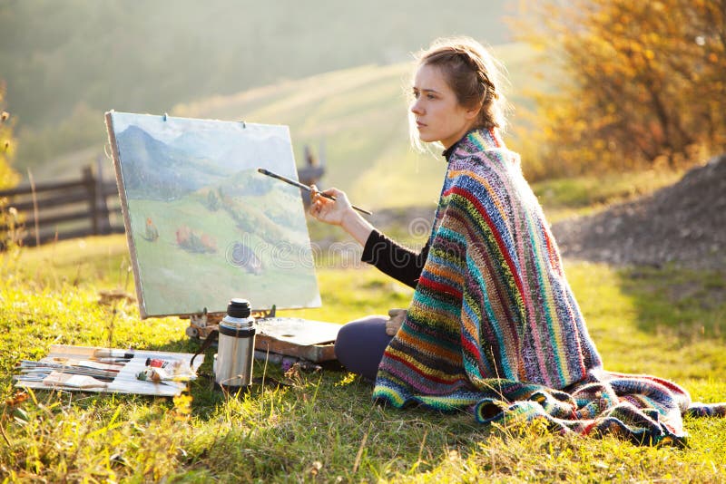 Young artist painting a landscape royalty free stock photography