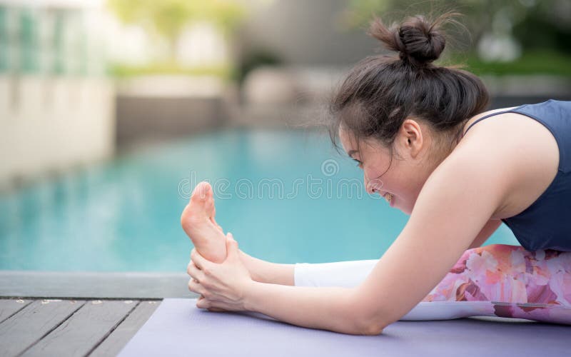 Young Asian woman doing yoga exercise near swimming pool royalty free stock photo Young Asian woman doing yoga exercise near swimming pool royalty free stock photo