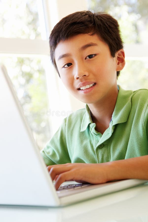 Young Asian boy using laptop stock image Young Asian boy using laptop stock image